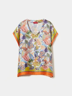 Blusa estilo poncho com padrão tropical