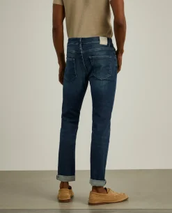 Calças denim lavagem escura slim fit