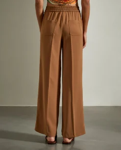 Calças fluidas de perna larga com cordão