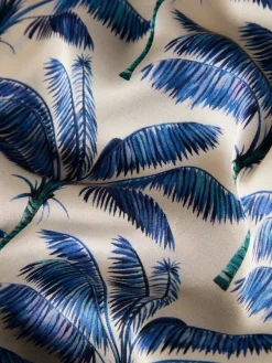 Calças pantalona com padrão de palmeiras